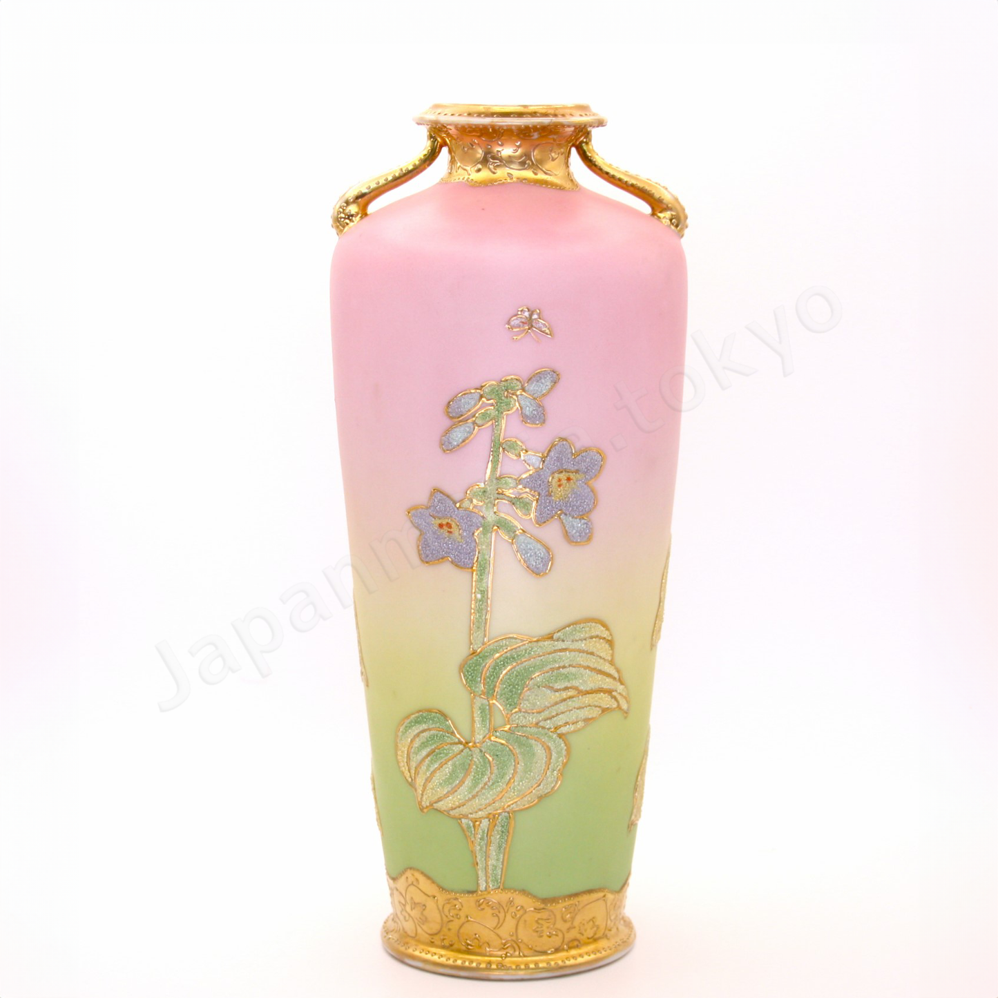 Back view: The Old Noritake CL-3 Vase, featuring a floral design with polychrome colors, delicate gold accents on the top and bottom, and beautiful coralene bead details. The background fades softly from pink at the top to cream and light green towards the base.