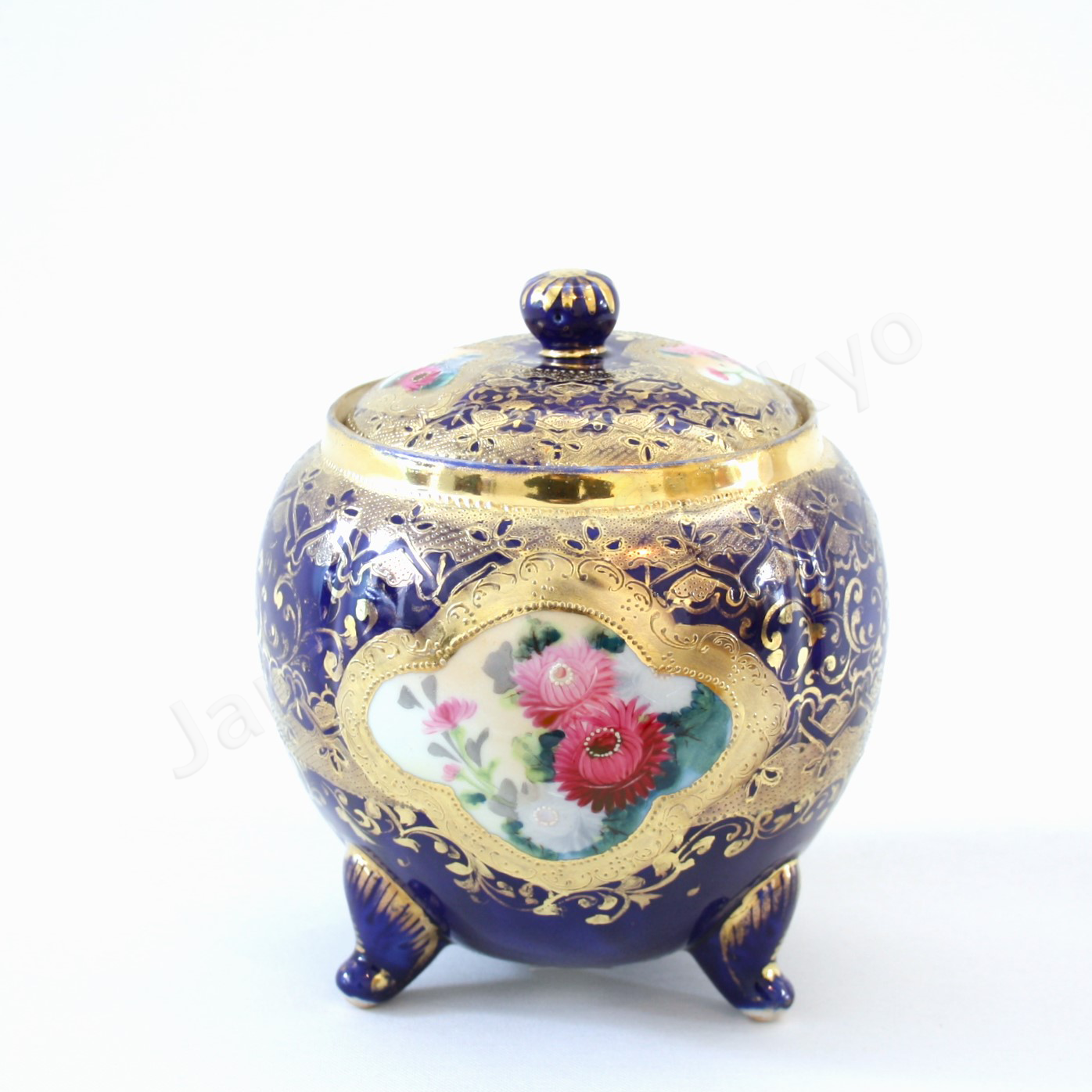 Front view: Japanese old fine china. Old Noritake.
Footed cookie jar with Chrysanthemum design
cobalt blue and gold relief