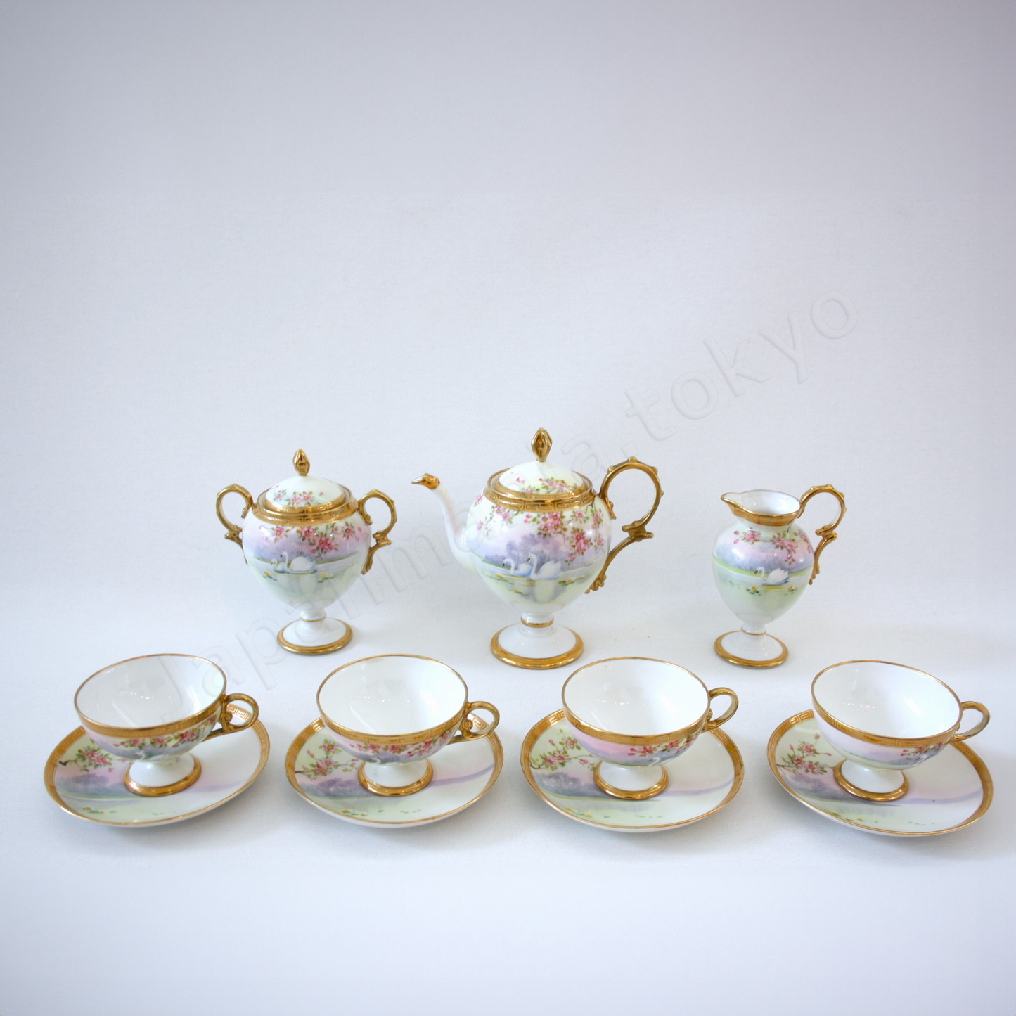 Front view: Japanese Antique fine china. Old Noritake.
Tea set
Swan and landscape design
Polychrome and gold