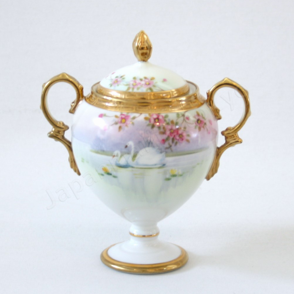 Front view: Japanese Antique fine china. Old Noritake.
Tea set
Swan and landscape design
Polychrome and gold