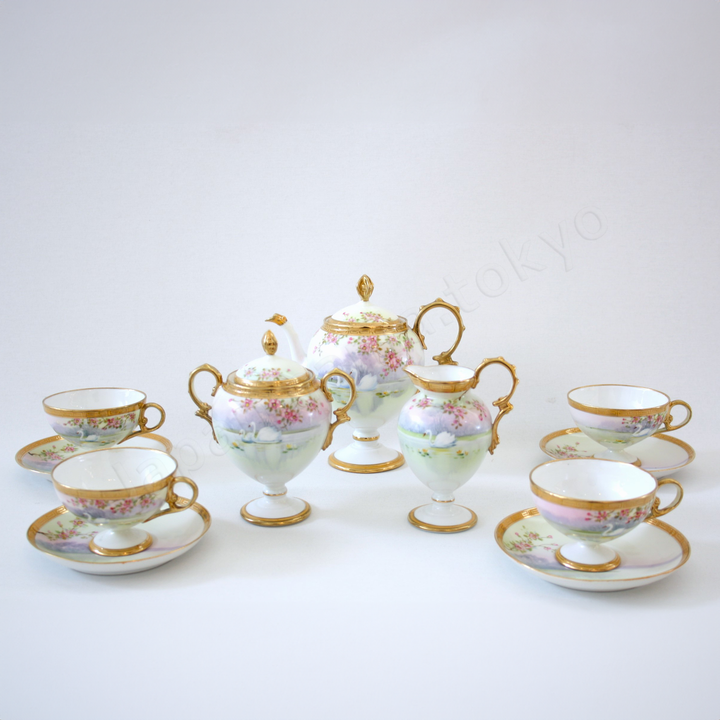 Front view: Japanese Antique fine china. Old Noritake.
Tea set
Swan and landscape design
Polychrome and gold