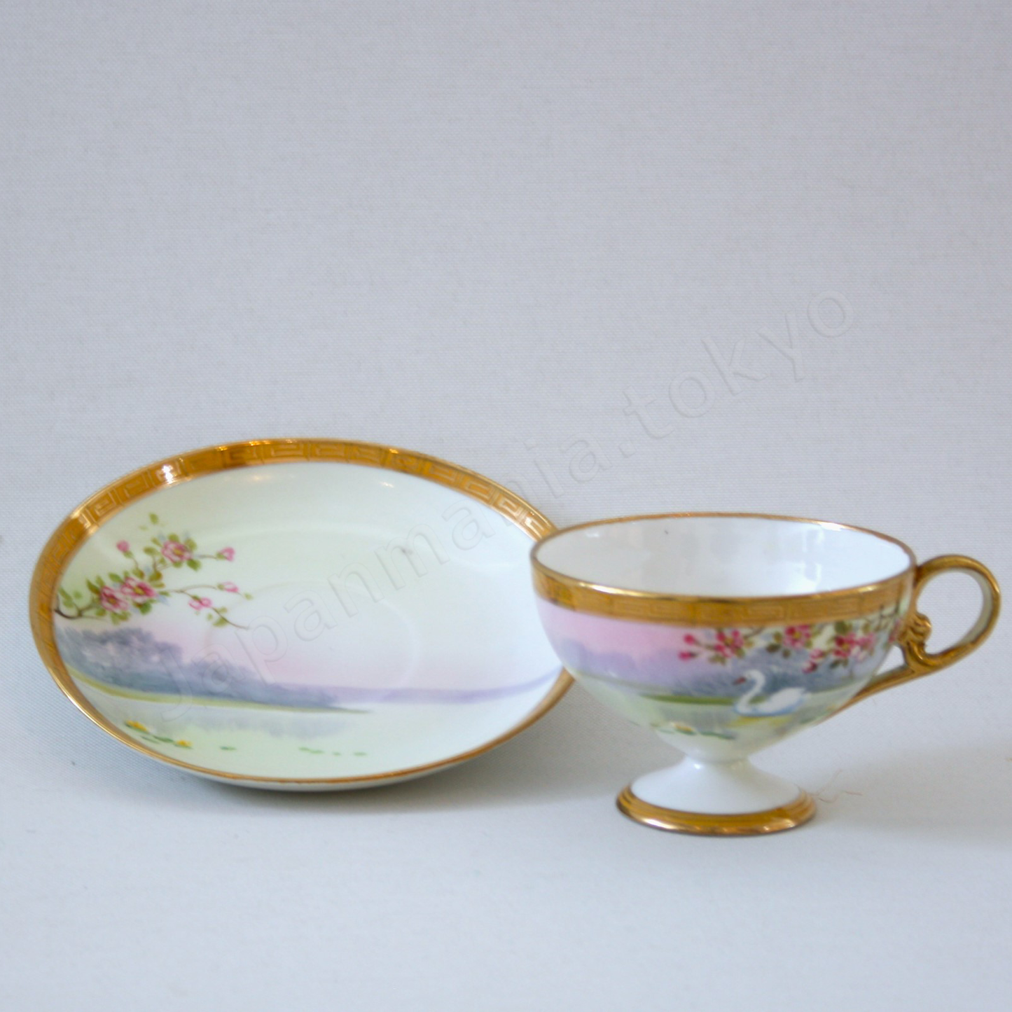 Front view: Japanese Antique fine china. Old Noritake.
Tea set
Swan and landscape design
Polychrome and gold
