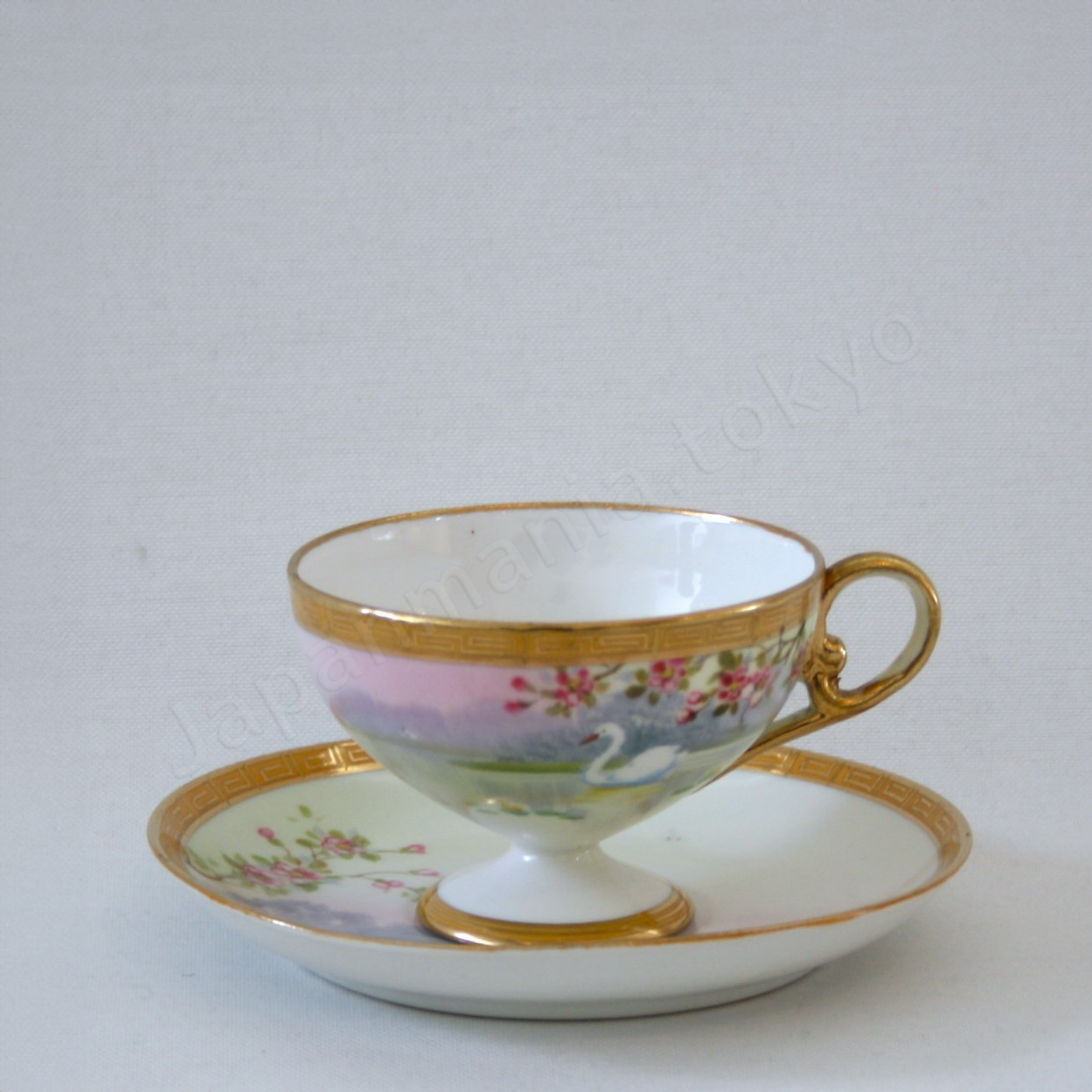 Front view: Japanese Antique fine china. Old Noritake.
Tea set
Swan and landscape design
Polychrome and gold