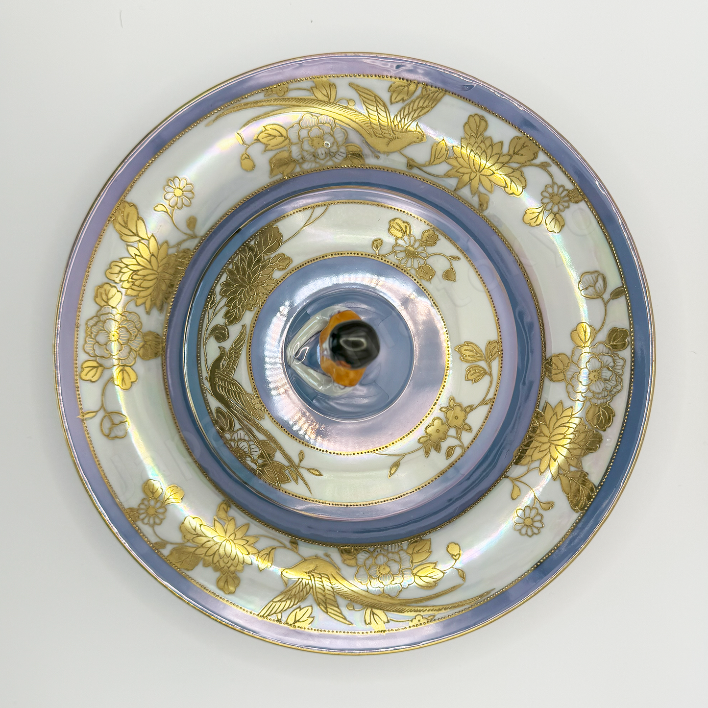 Top view: Japanese antique fine china. Old Noritake, Dip Dish, showcasing its unique Art Deco style and a lady-shaped lid with vibrant floral motifs and a beautiful polychrome luster finish.