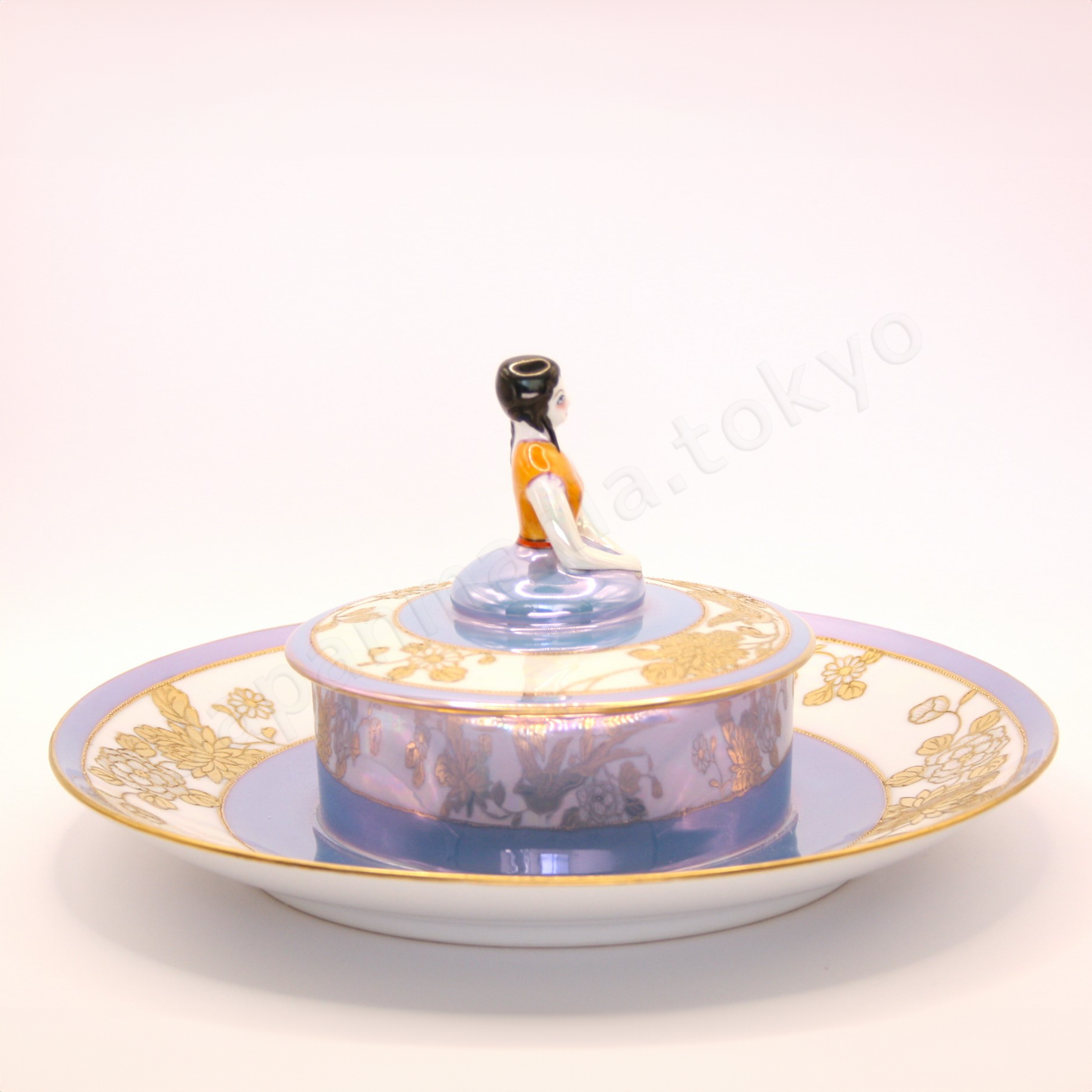 Side view: Japanese antique fine china. Old Noritake, Dip Dish, showcasing its unique Art Deco style and a lady-shaped lid with vibrant floral motifs and a beautiful polychrome luster finish.