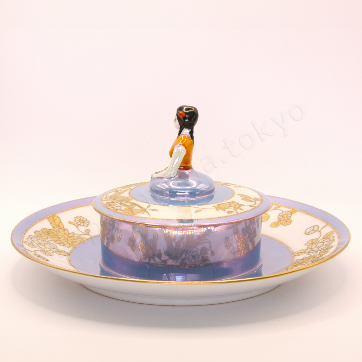 Side view: Japanese antique fine china. Old Noritake, Dip Dish, showcasing its unique Art Deco style and a lady-shaped lid with vibrant floral motifs and a beautiful polychrome luster finish.