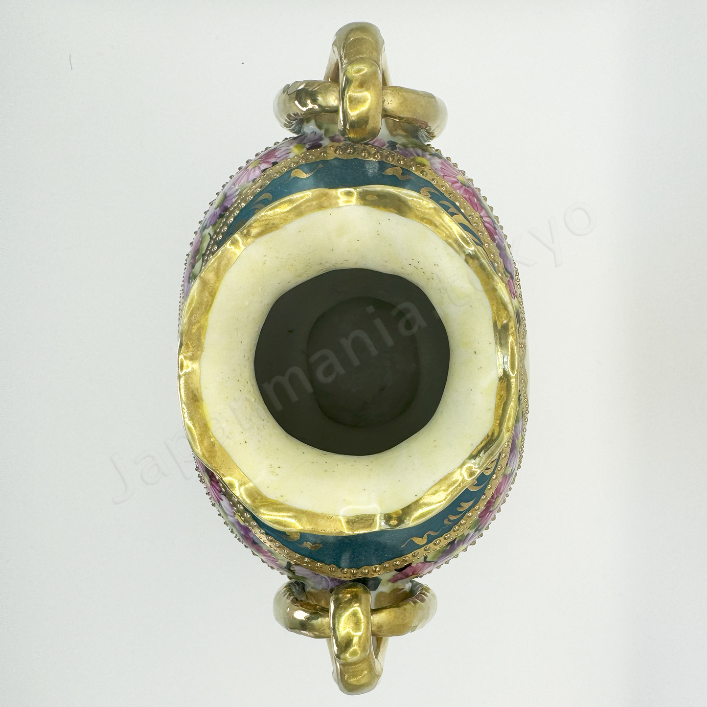 Top view: Japanese antique fine china, Old Noritake.
Vase, featuring rose motifs and gold relief detailing, with pretzel-shaped handles adding a unique touch.