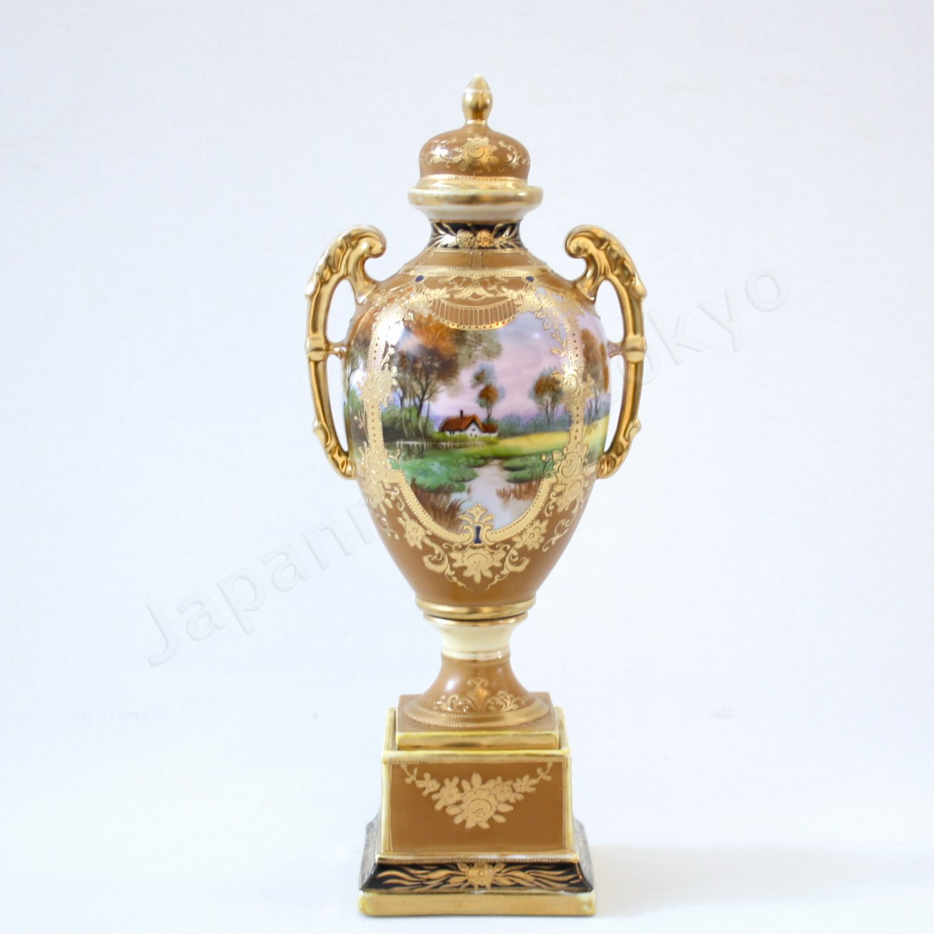 Front view: Japanese antique fine china, Old Noritake.
Bolted urn with lid & handles
Landscape design
polychrome and gold