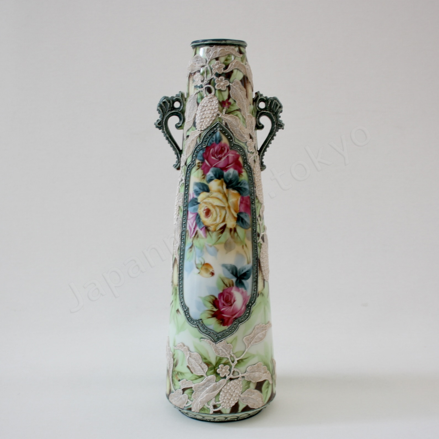 Front view: Japanese antique fine china, Old Noritake.
Vase with handles
Rose and Berry design
polychrome, Moriage decoration