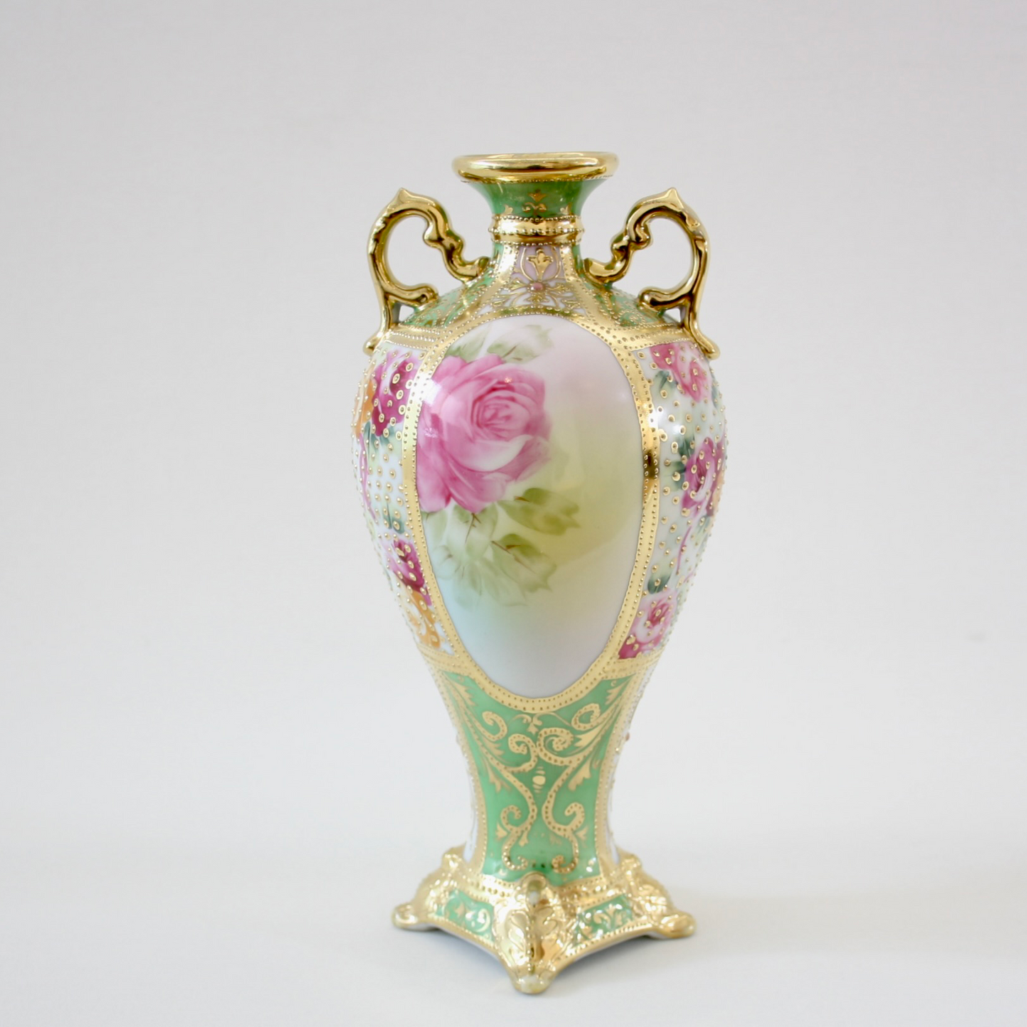 Back view: Japanese antique fine china, Old Noritake.
Decorated pot with handles
Rose design
Polychrome and dotted gold relief