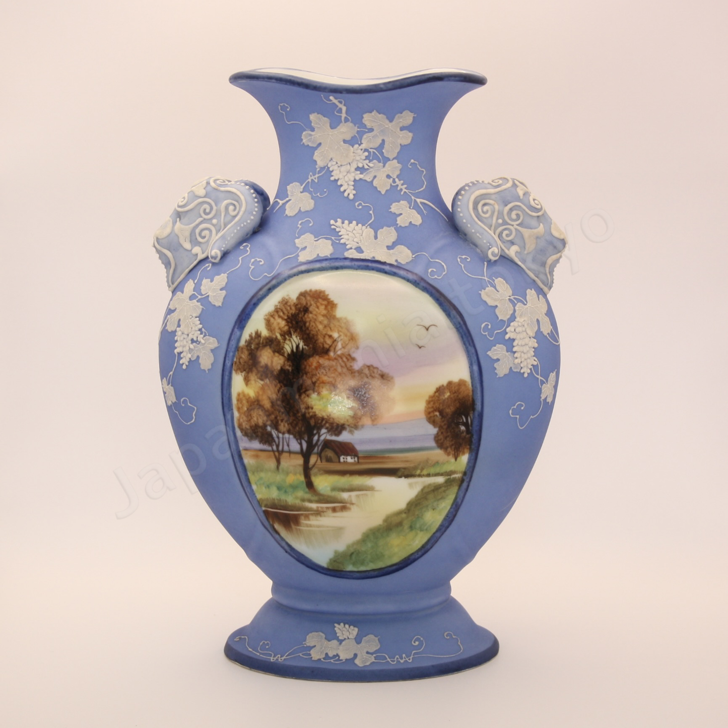 Front view: Japanese antique fine china, Old Noritake.
Vase with handles
Landscape design
Polychrome and while relief (Jasper ware style)