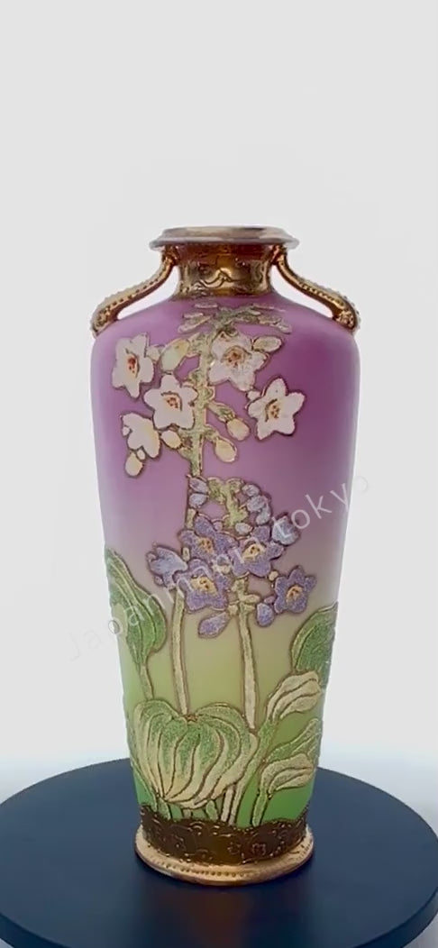 The Old Noritake CL-3 Vase, featuring a floral design with polychrome colors, delicate gold accents on the top and bottom, and beautiful coralene bead details. The background fades softly from pink at the top to cream and light green towards the base.